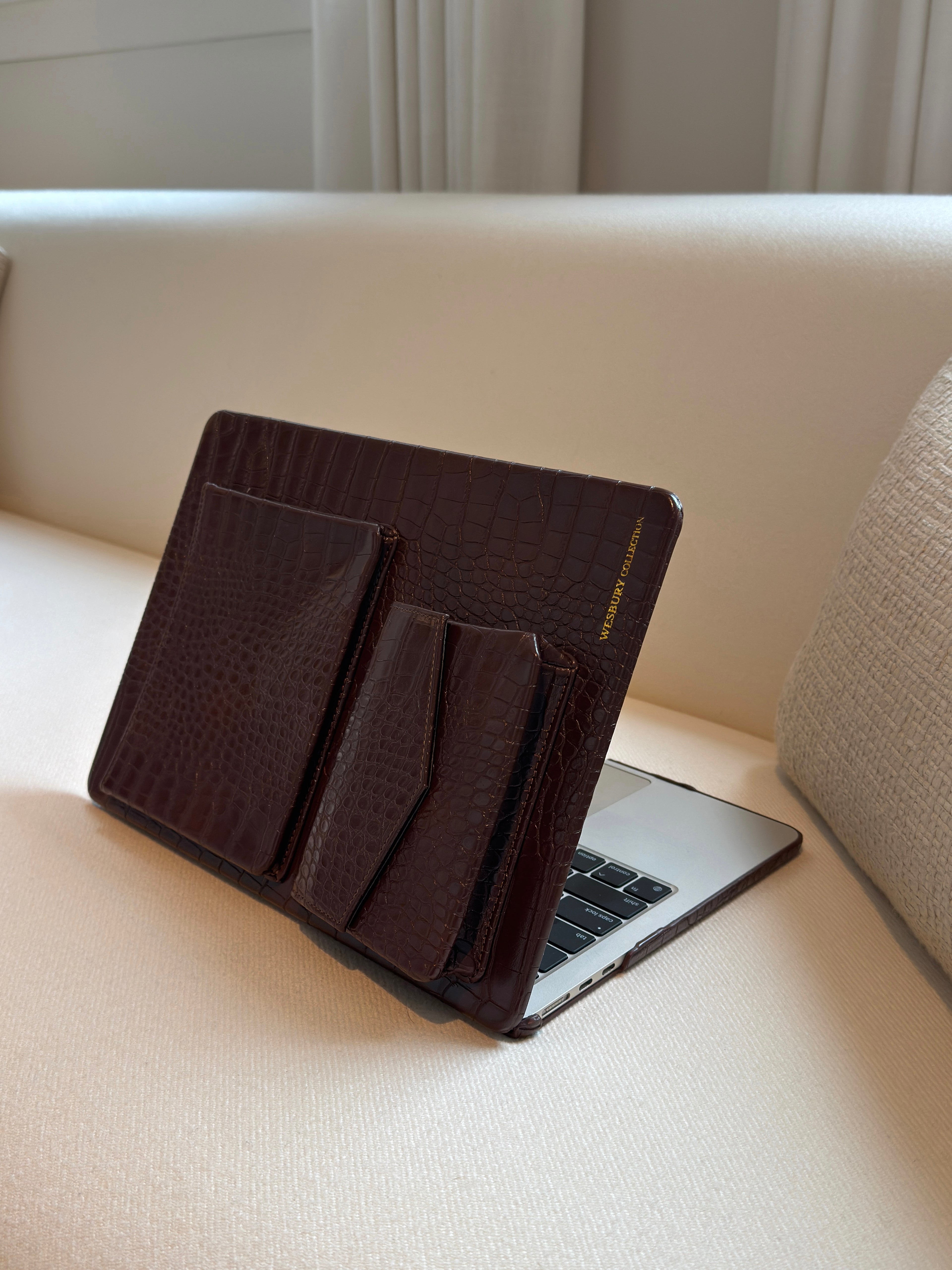 sloane macbook case sitting open on a couch