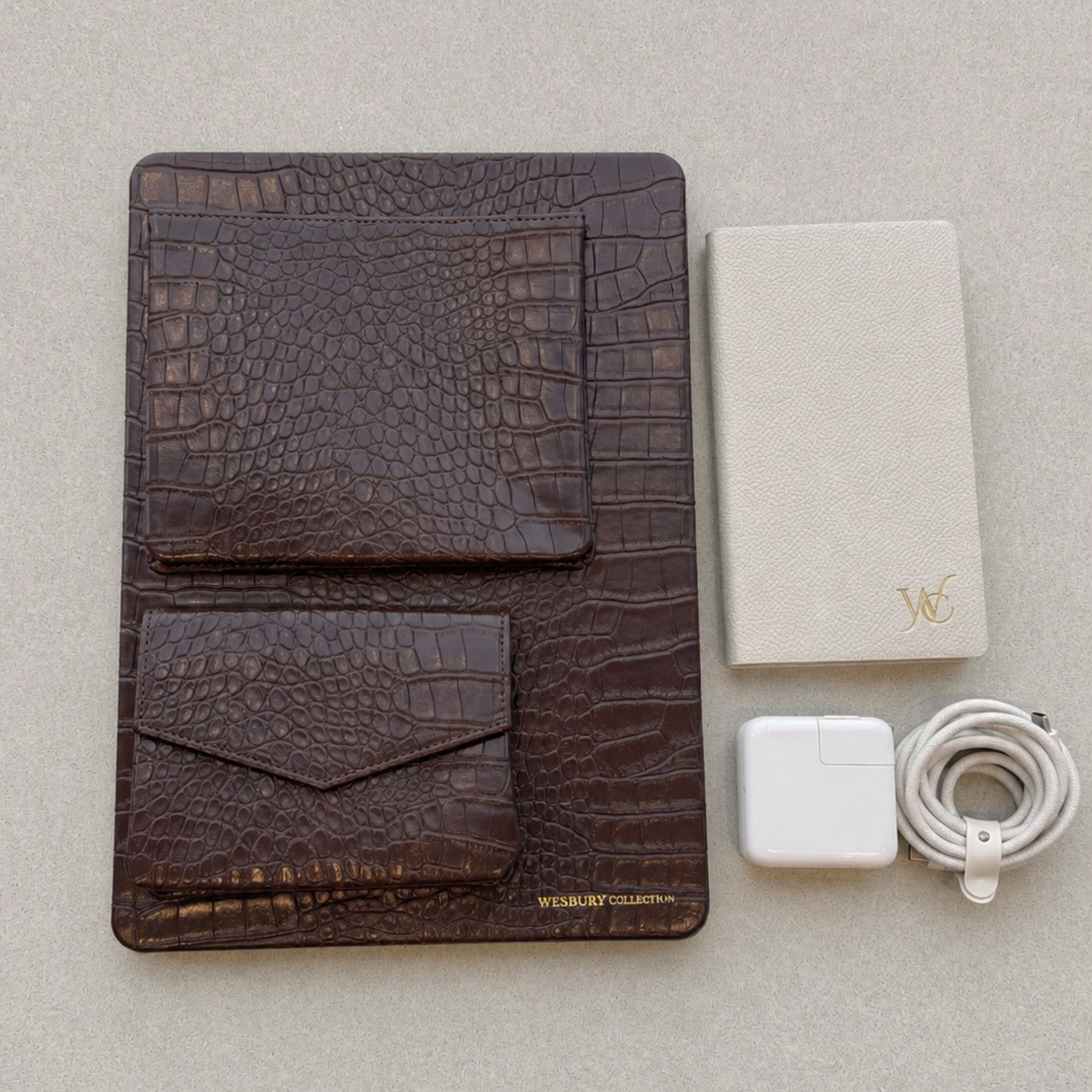 websury macbook case with notebook, charger, and cable